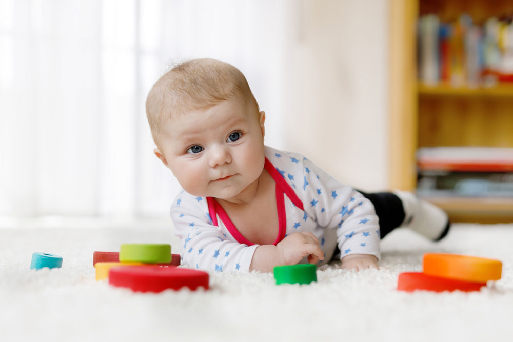 newborn playing on tummy